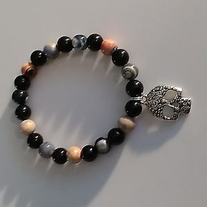 Orange and Black stretch bracelet with skull charm